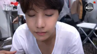 j-hope is trying to wear contact lenses.